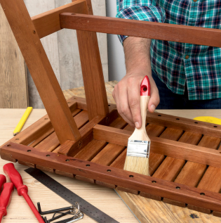 applying wooden paint on a furniture