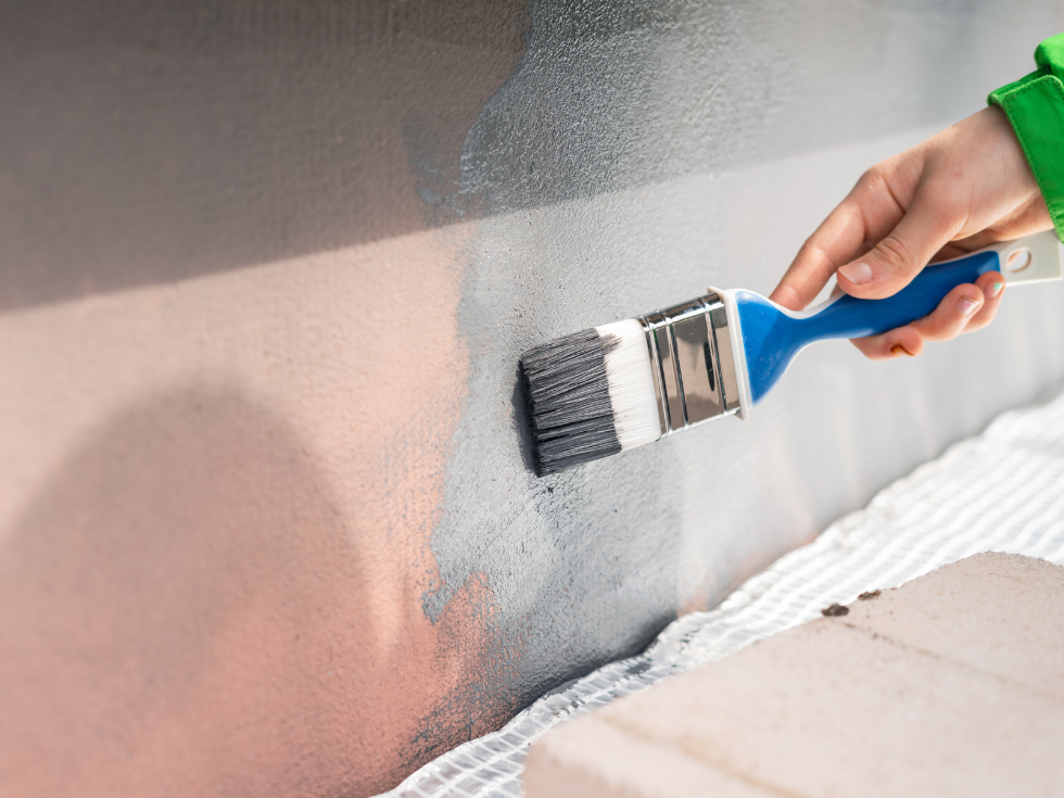 Painting A Wall Grey With A Blue Paint Brush - Asian Paints