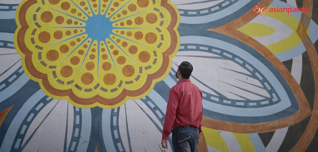 A person looking at a graffiti on a wall