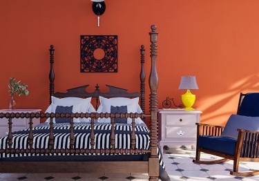 Rustic Bedroom with Orange Wall