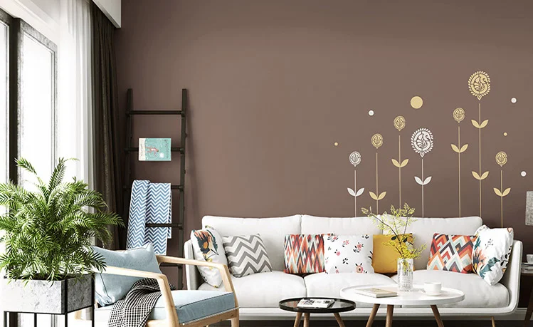 A modern living room with white and blue room decor and a planter.