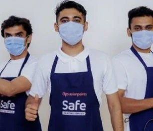 3 Men Standing Side to Side wearing  Blue Masks and Aprons. Blog on "Top 7 Things to Consider Before Painting The House."