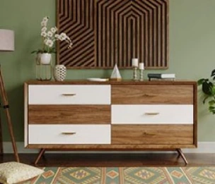 A Beautiful Brown and White Wood Finished Chest Drawer with a Geometric Patterned Painting hanging over the Dark Pastel Wall.